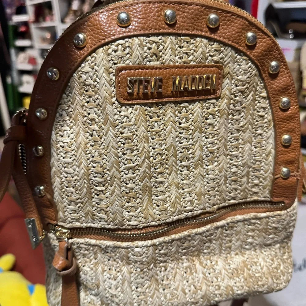 brown leather steve madden backpack Women's Riggs Bag - Distressed Featuring dome stud details and knotted fringe decals on a gusset with rounded bottom metal aglets Steve Madden Brown and Cream